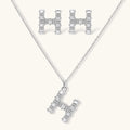 Letter H jewelry set featuring geometric crystal design in gold and white gold plated finish with adjustable chain necklace