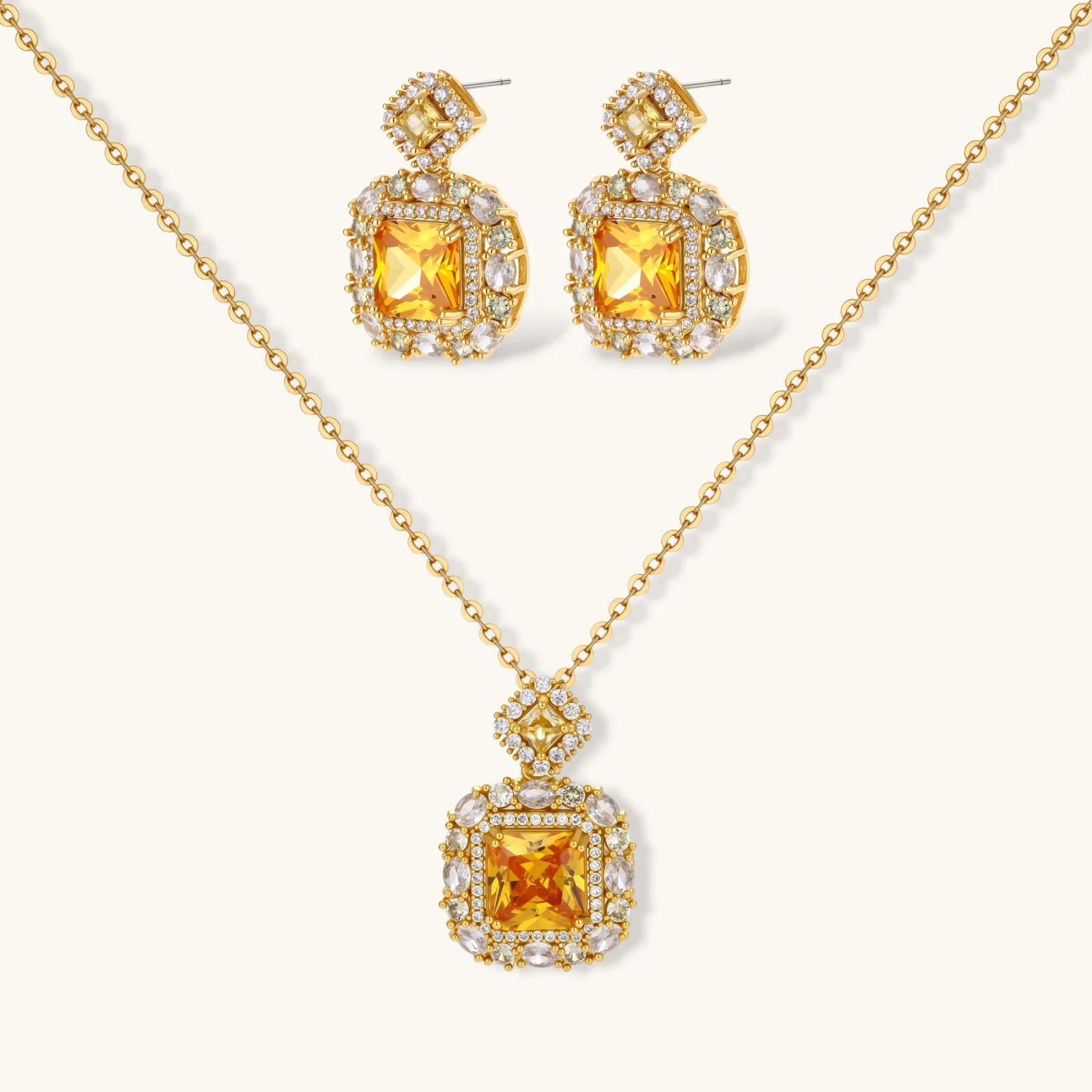 14K gold-plated jewelry set featuring square-cut cubic zirconia stones in ornate layered settings on white background.