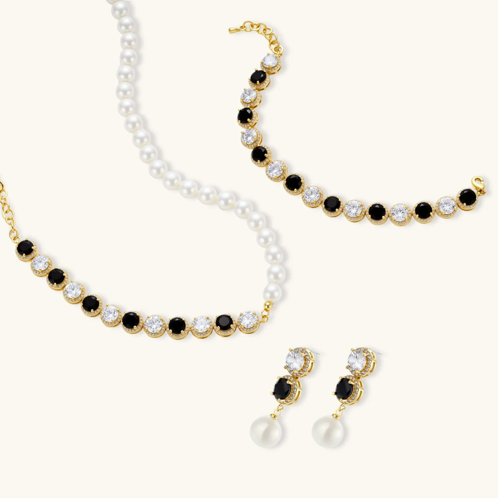 Gold-plated jewelry set with alternating black and clear cubic zirconia stones, featuring necklace, earrings and bracelet