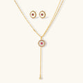 Gold-plated circular medallion necklace set with white enamel base and pink cubic zirconia accent stones