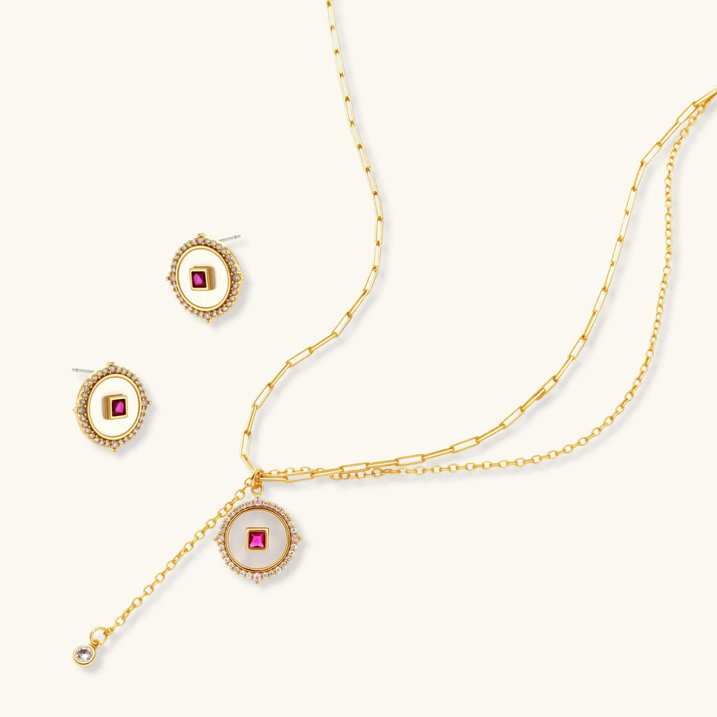 Gold-plated circular medallion necklace set with white enamel base and pink cubic zirconia accent stones