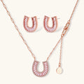 Sparkling horseshoe-shaped jewelry set with AAA cubic zirconia in gold-plated and white gold finishes on cream background.