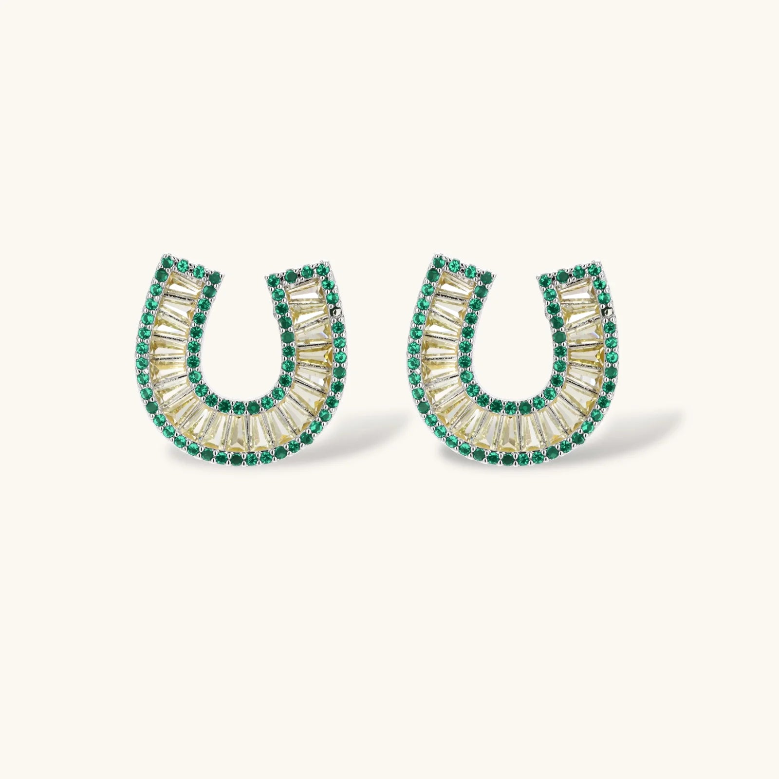 Sparkling horseshoe-shaped jewelry set with AAA cubic zirconia in gold-plated and white gold finishes on cream background.