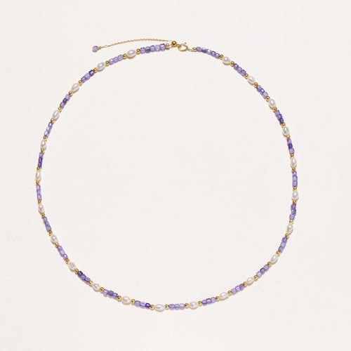 Delicate 18K gold vermeil necklace with alternating lavender zirconia beads and white freshwater pearls on cream background